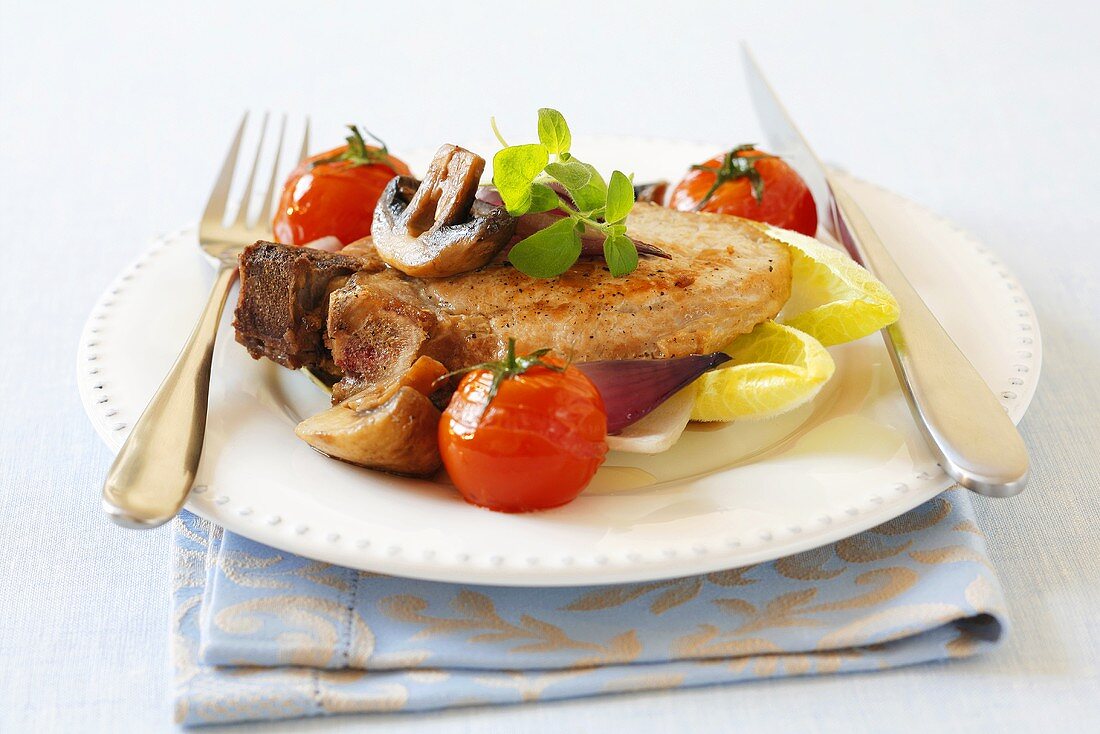 Pork chop with mushrooms, tomatoes and onions