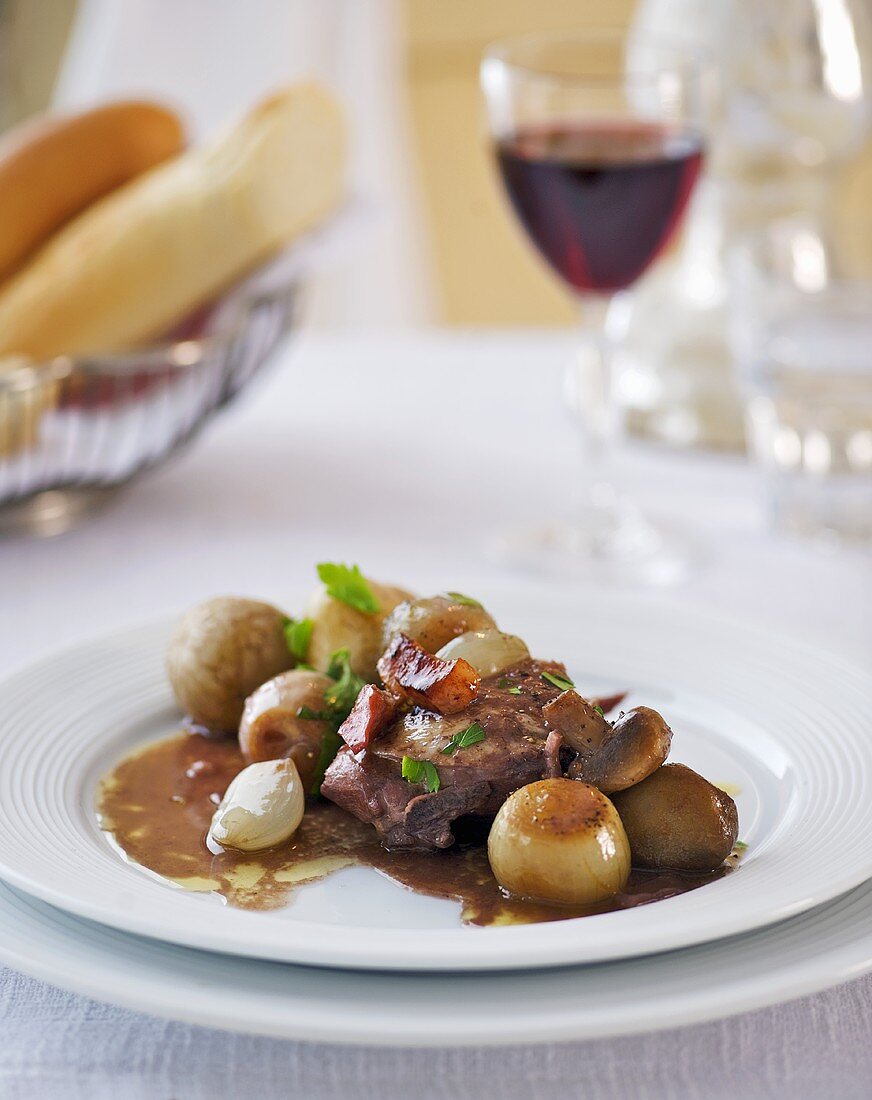 Coq au vin with onions and potatoes (France)
