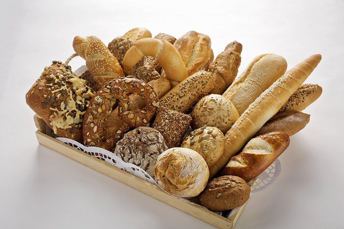 Assorted bread rolls and pretzels on tray