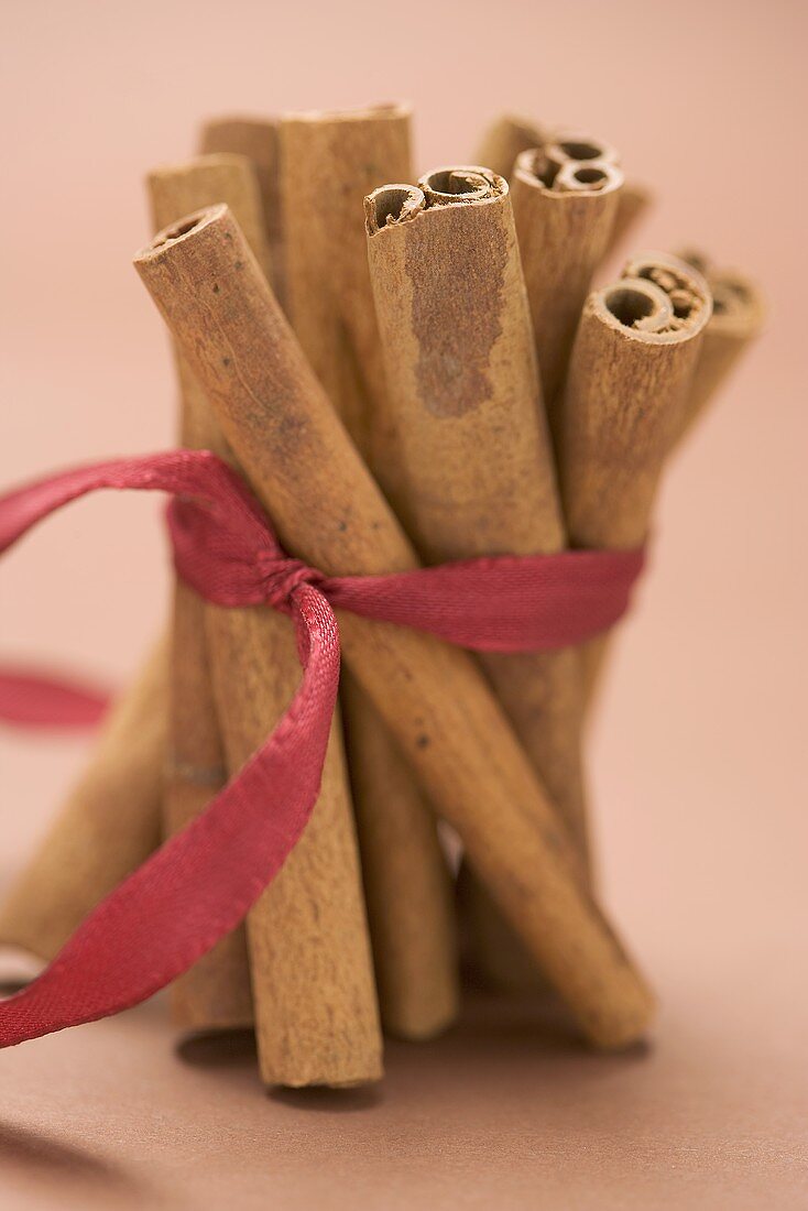 Cinnamon sticks, tied together with red ribbon