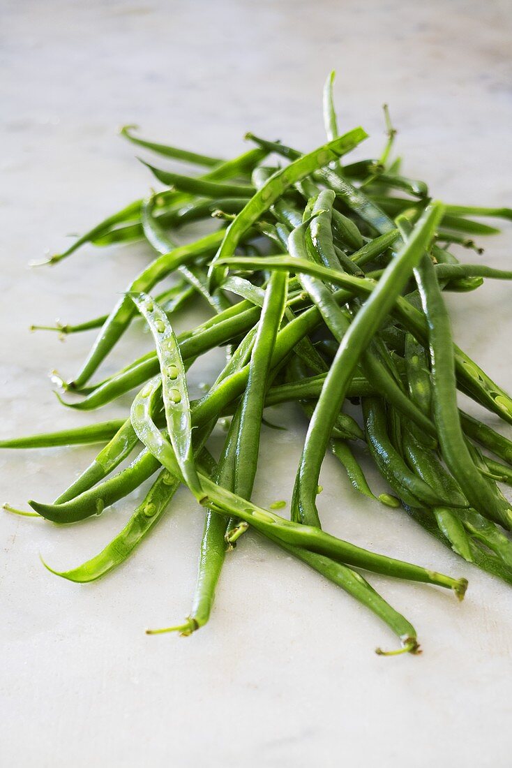 Green beans on marble surface