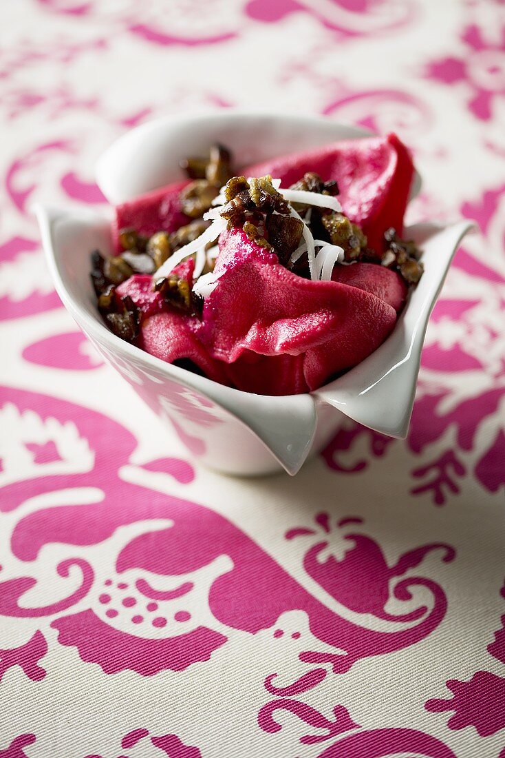 Home-made beetroot pasta with grated mozzarella