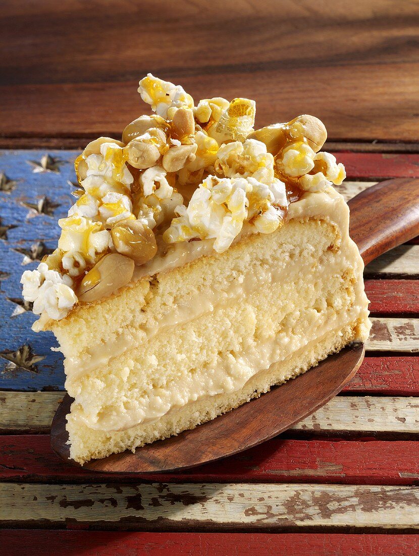 Sponge cake with peanuts, soft cheese and popcorn