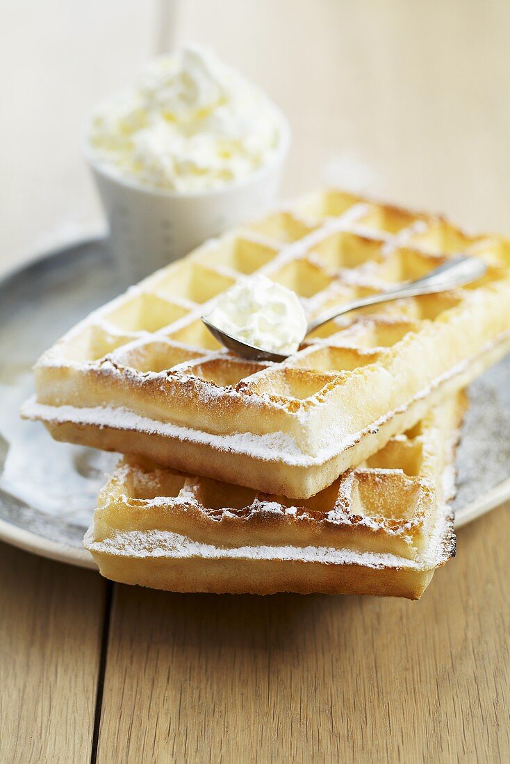 Waffles with cream and icing sugar