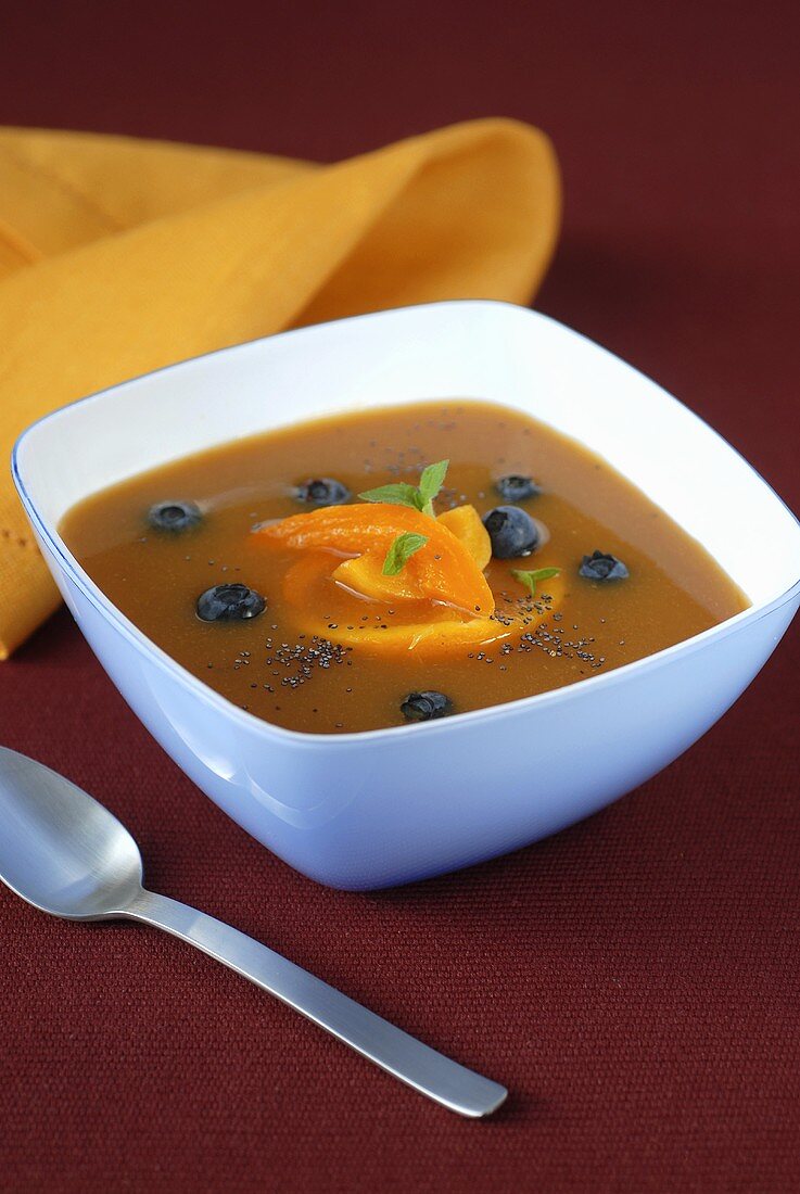 Peach soup with blueberries and poppy seeds