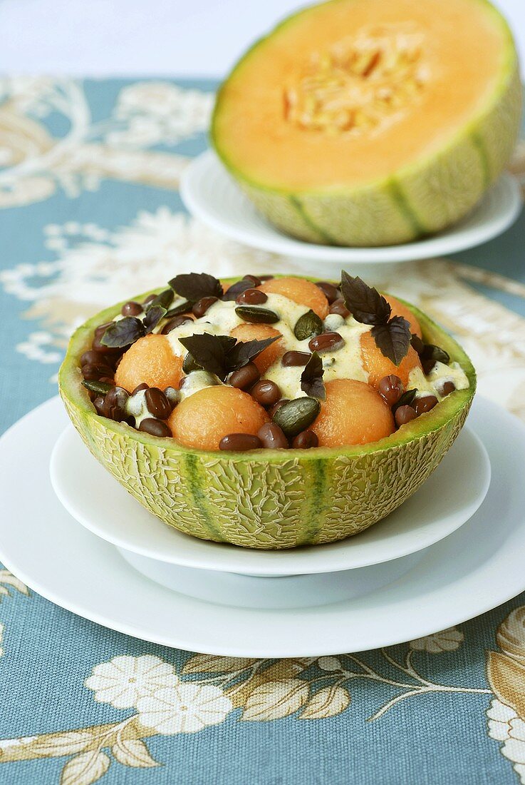 Bean & melon salad with pumpkin seeds in hollowed-out melon