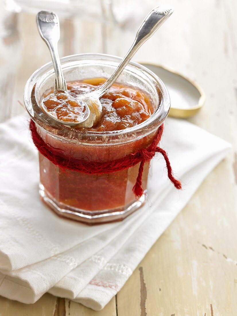 Rhubarb jam in jam jar with spoons