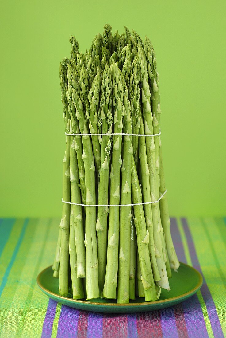 A bundle of green asparagus on plate