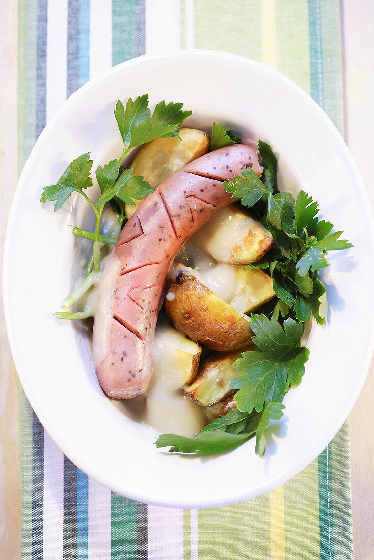 Sausage with potato wedges and parsley