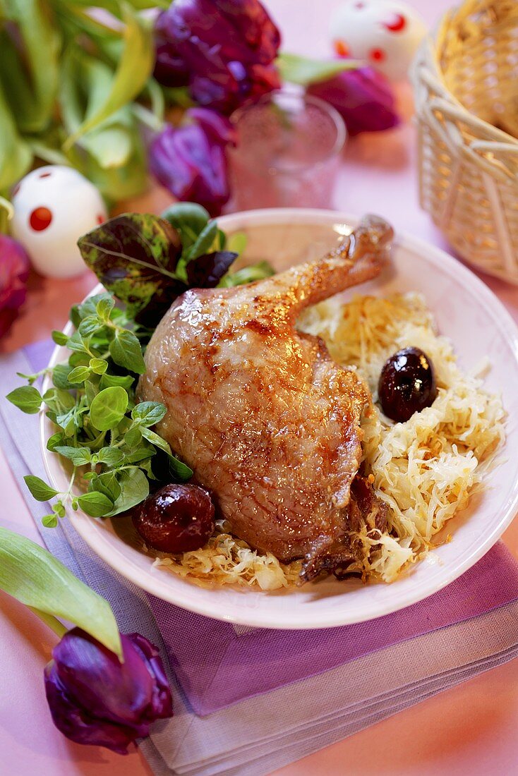 Goose leg on sauerkraut with grapes for Easter