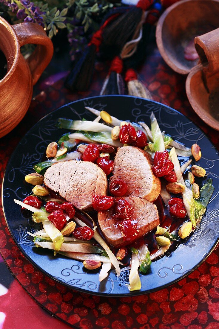 Pork medallions with cherries and pistachios