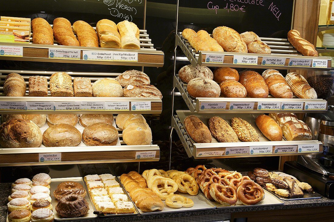 Assorted bread and pastries on shelves in a bakery