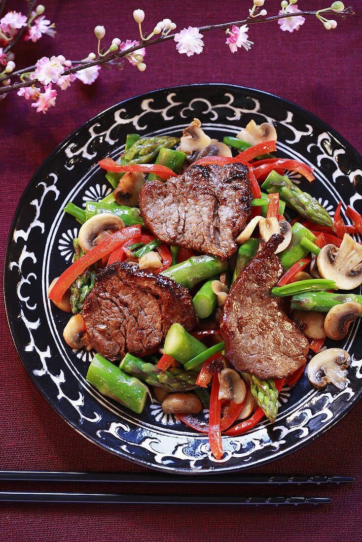 Gingered beef medallions on a bed of vegetables