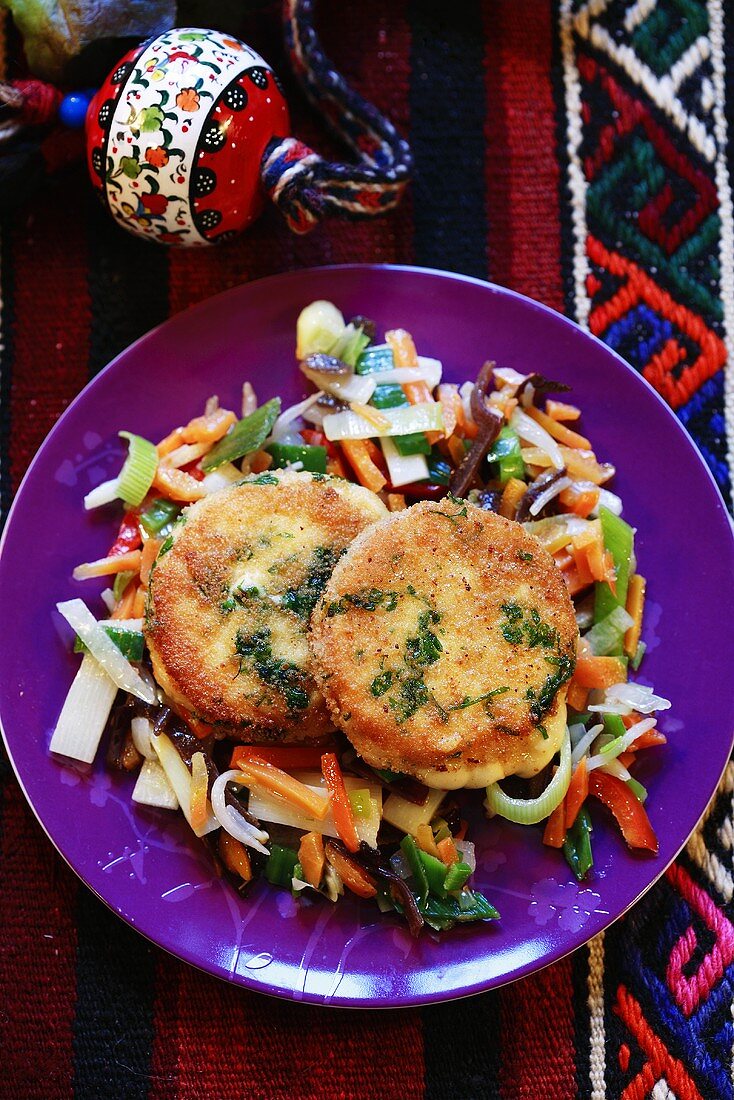 Fried cheese on a bed of vegetables