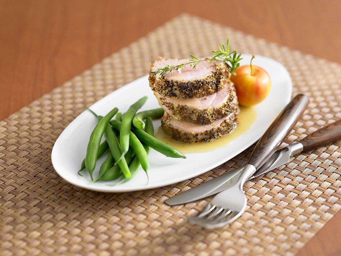 Roast loin of pork with crust and green beans