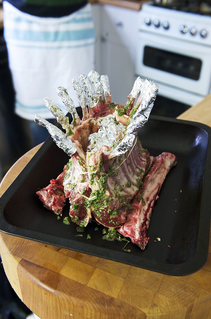 Raw rack of lamb in roasting tin