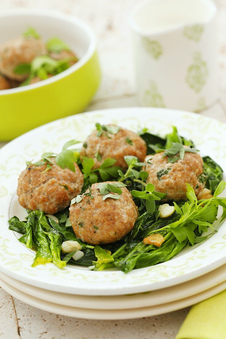 Meatballs with herbs on spinach