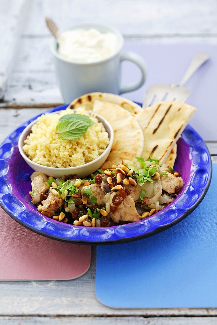 Chicken breast with raisins, pine nuts, pita bread & couscous