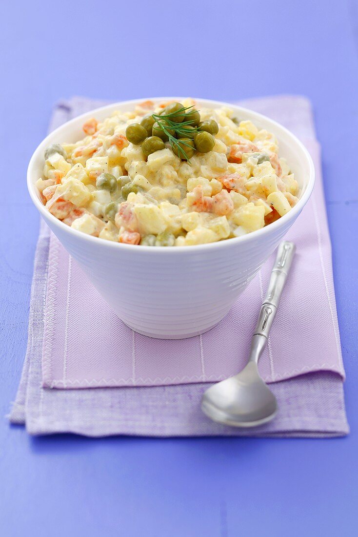 A bowl of vegetable salad with apple and egg in mayonnaise