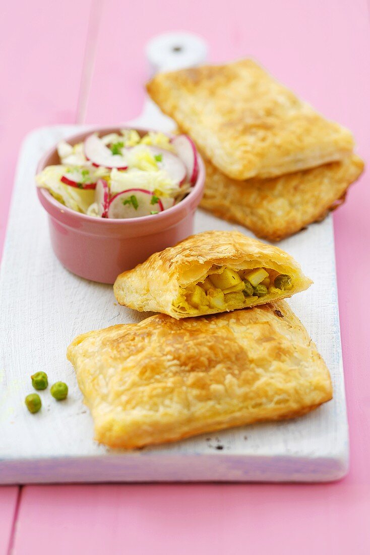 Puff pastry pasties with potato and pea filling