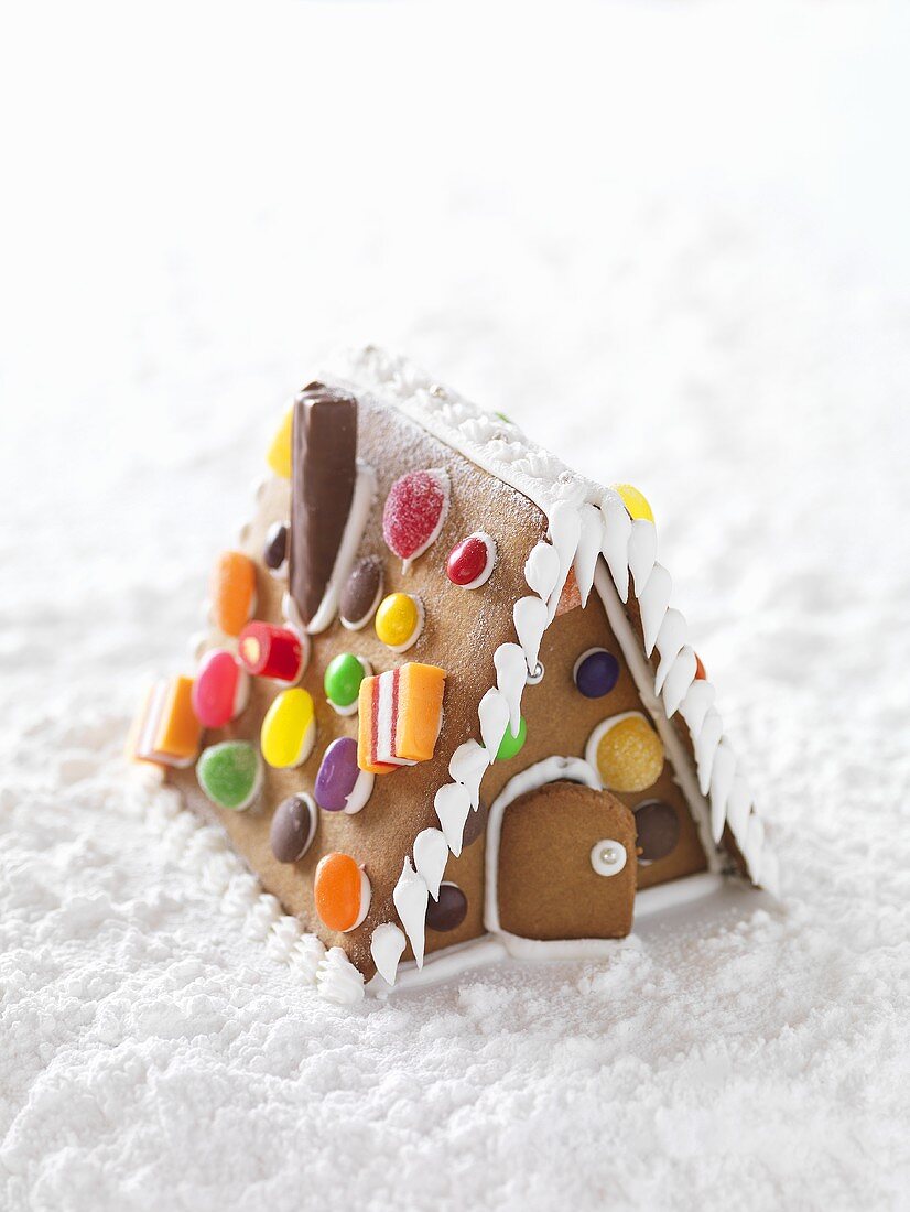 A gingerbread house with icing sugar snow
