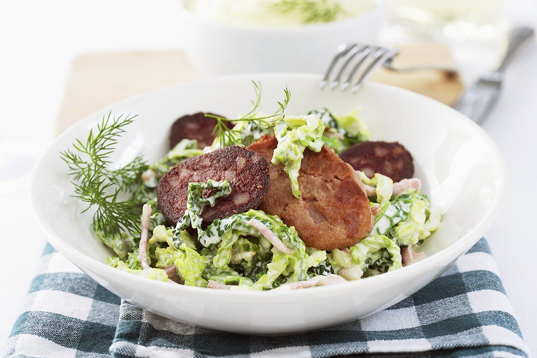 Creamed savoy cabbage with fried bacon and black pudding