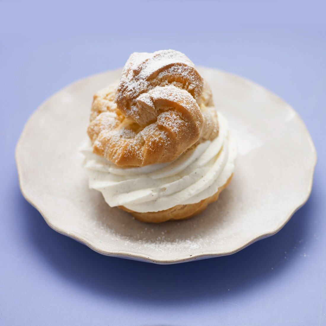 A fresh profiterole filled with cream