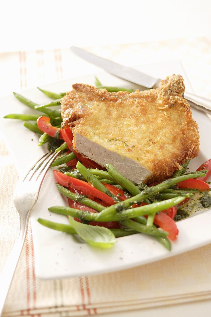 Pork chop with Parmesan crust and beans