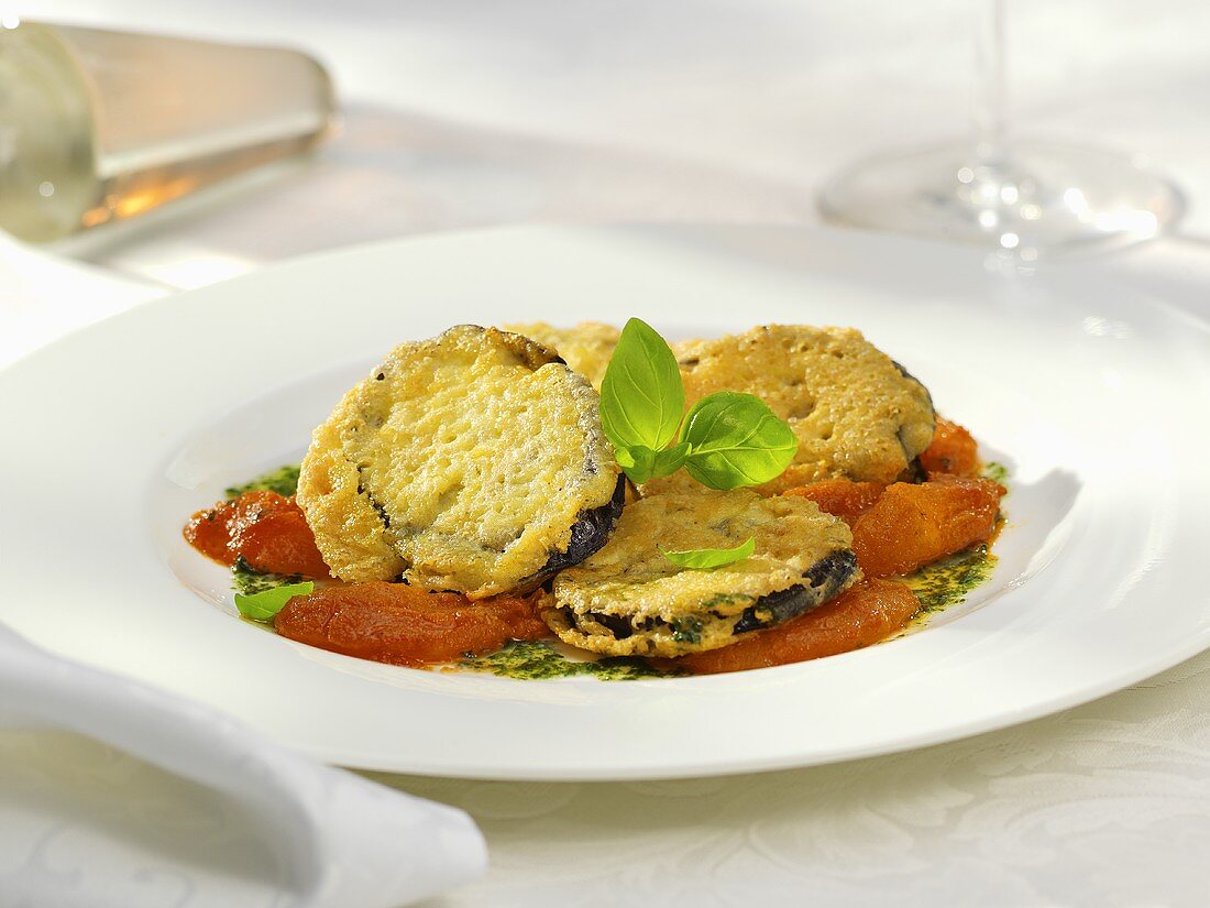 Aubergine slices with cheese crust on tomatoes