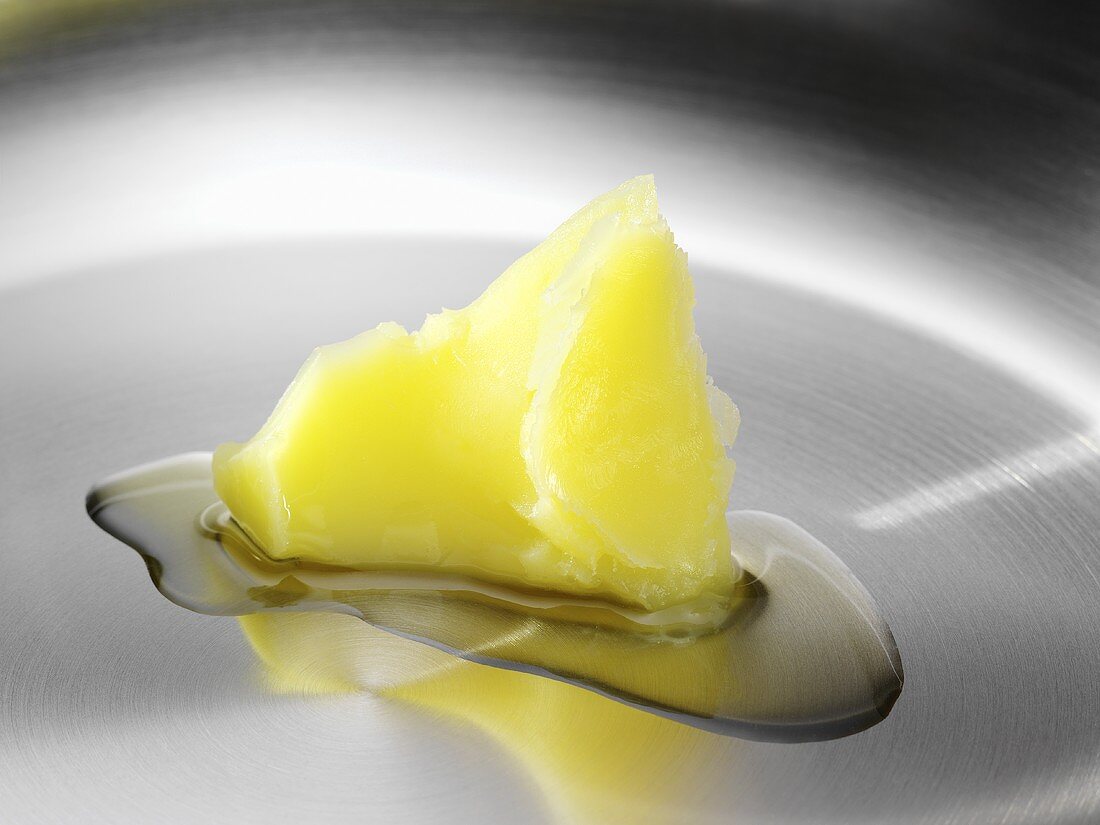 Warming clarified butter in a frying pan