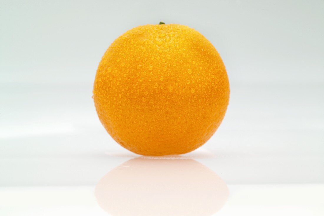 An orange with drops of water