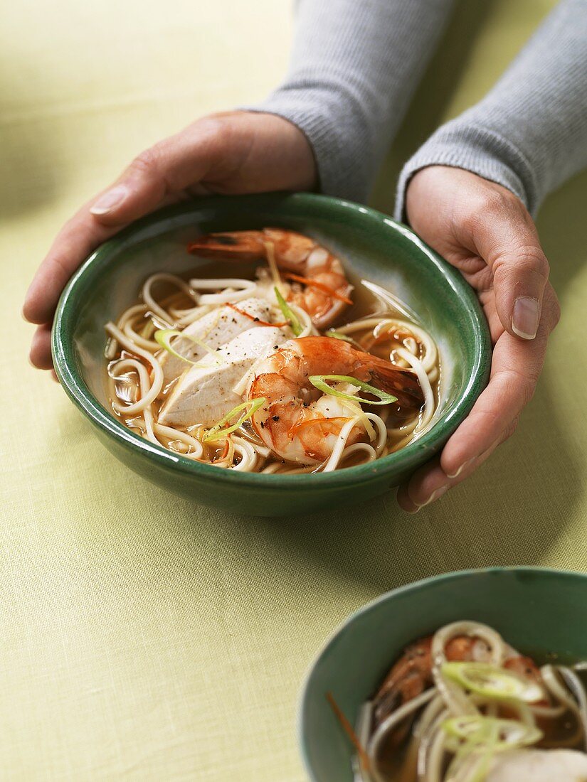Asian noodle soup with chicken and prawns