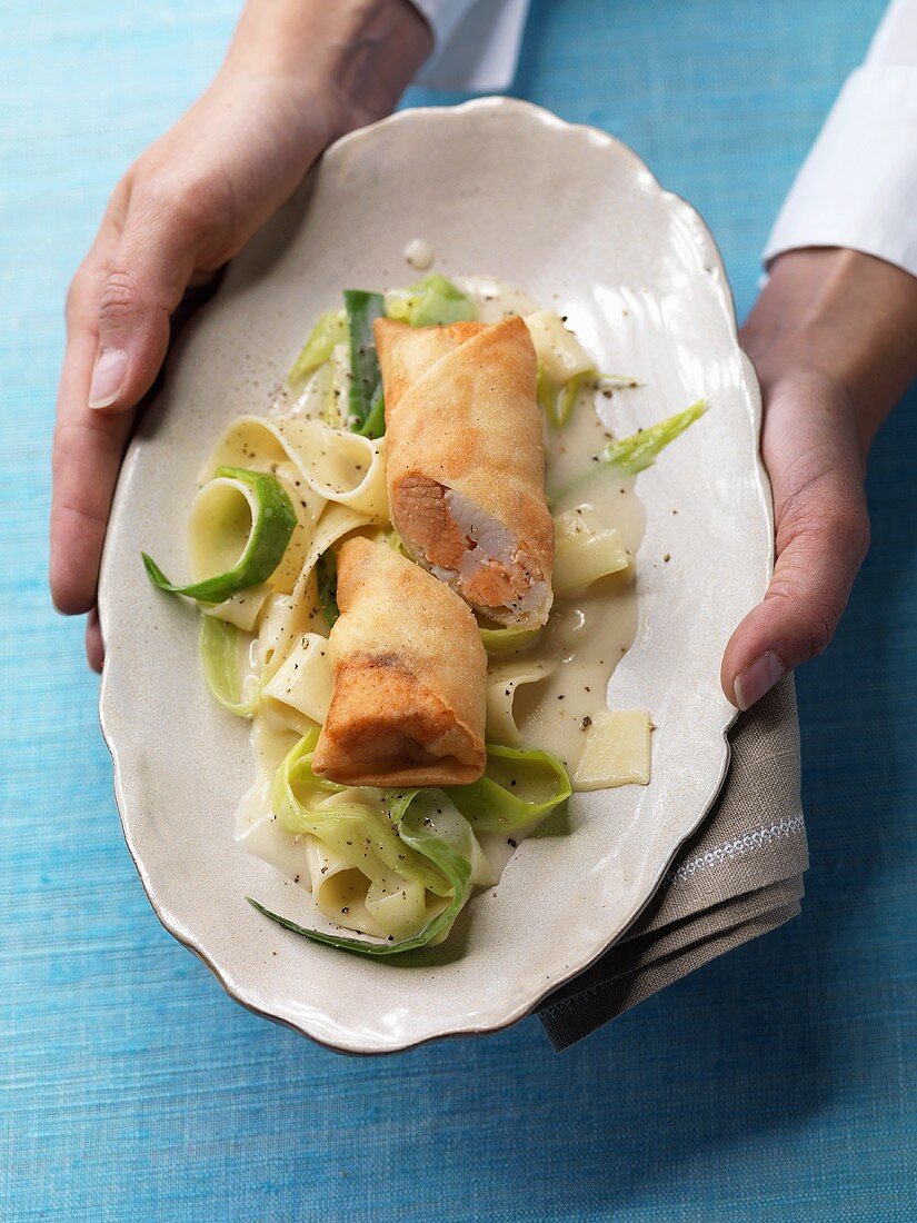 Fish spring roll on leeks and noodles