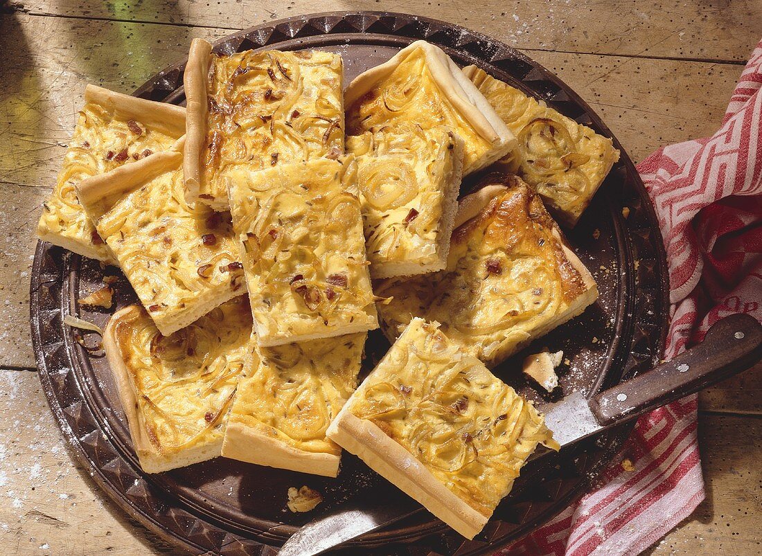 Pieces of tray-baked onion tart