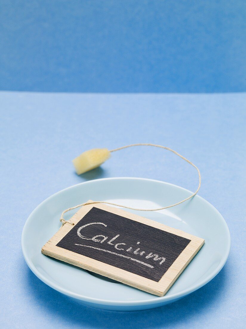 Slate board with the word Calcium on blue plate