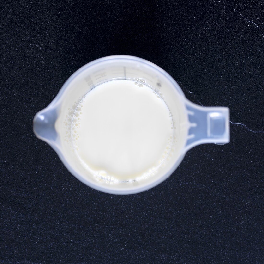 Cream in measuring jug