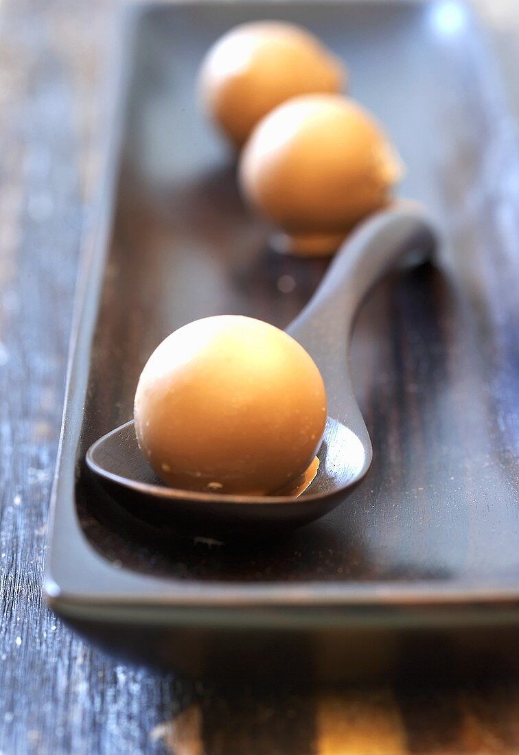 Gianduja truffles, one on spoon