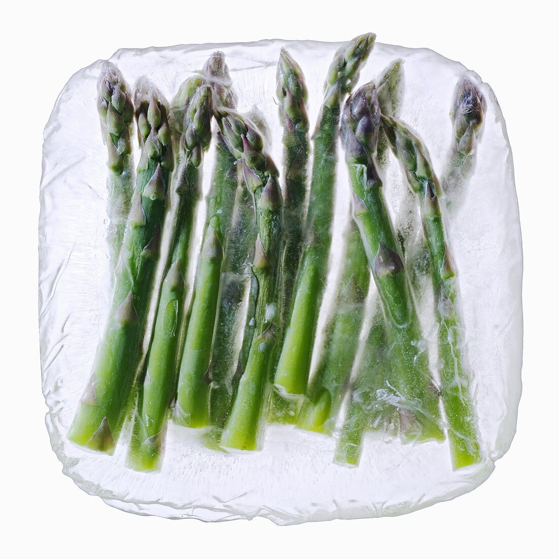 Green asparagus in a block of ice