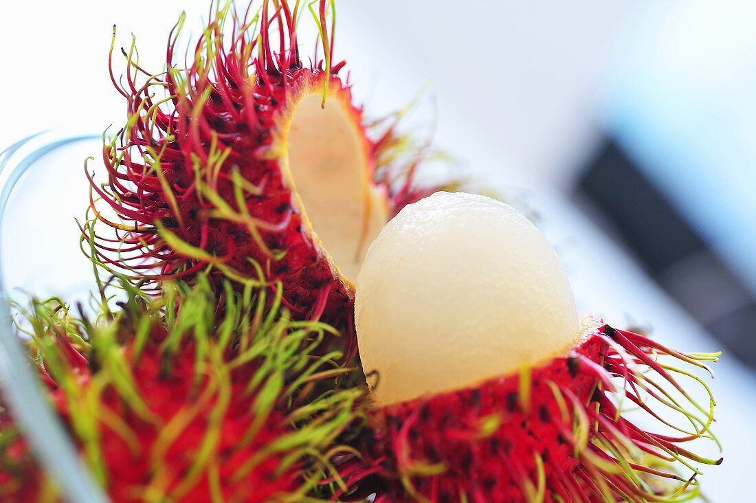 Rambutans, one peeled, one unpeeled