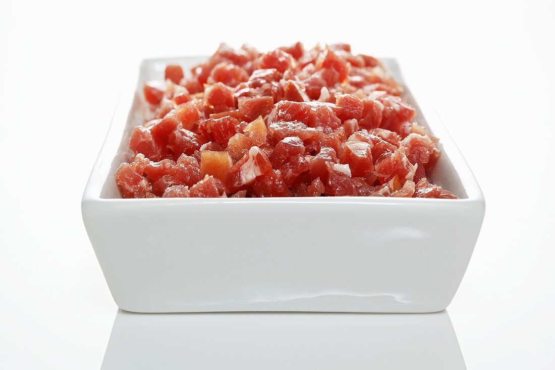 Diced raw ham in rectangular dish