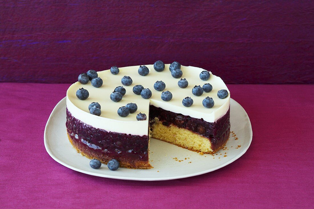 Blueberry cream cake, a piece removed