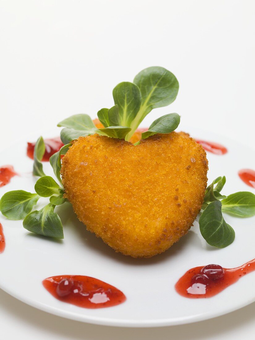 Deep-fried Camembert heart with corn salad & cranberry sauce