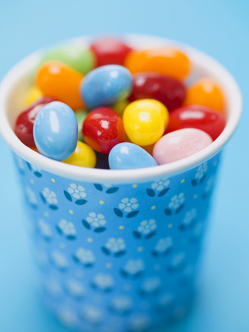 Coloured jelly beans in a beaker