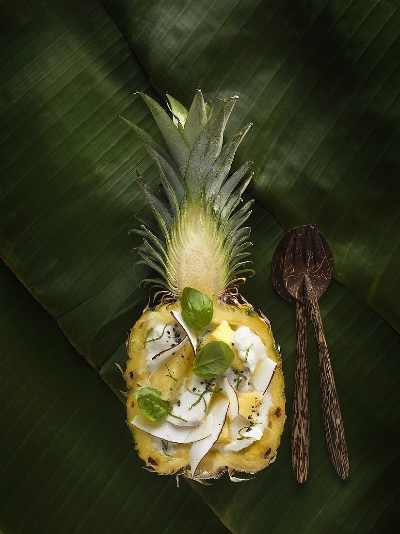 Bacalao pina colada (Cod with coconut sauce in pineapple half)