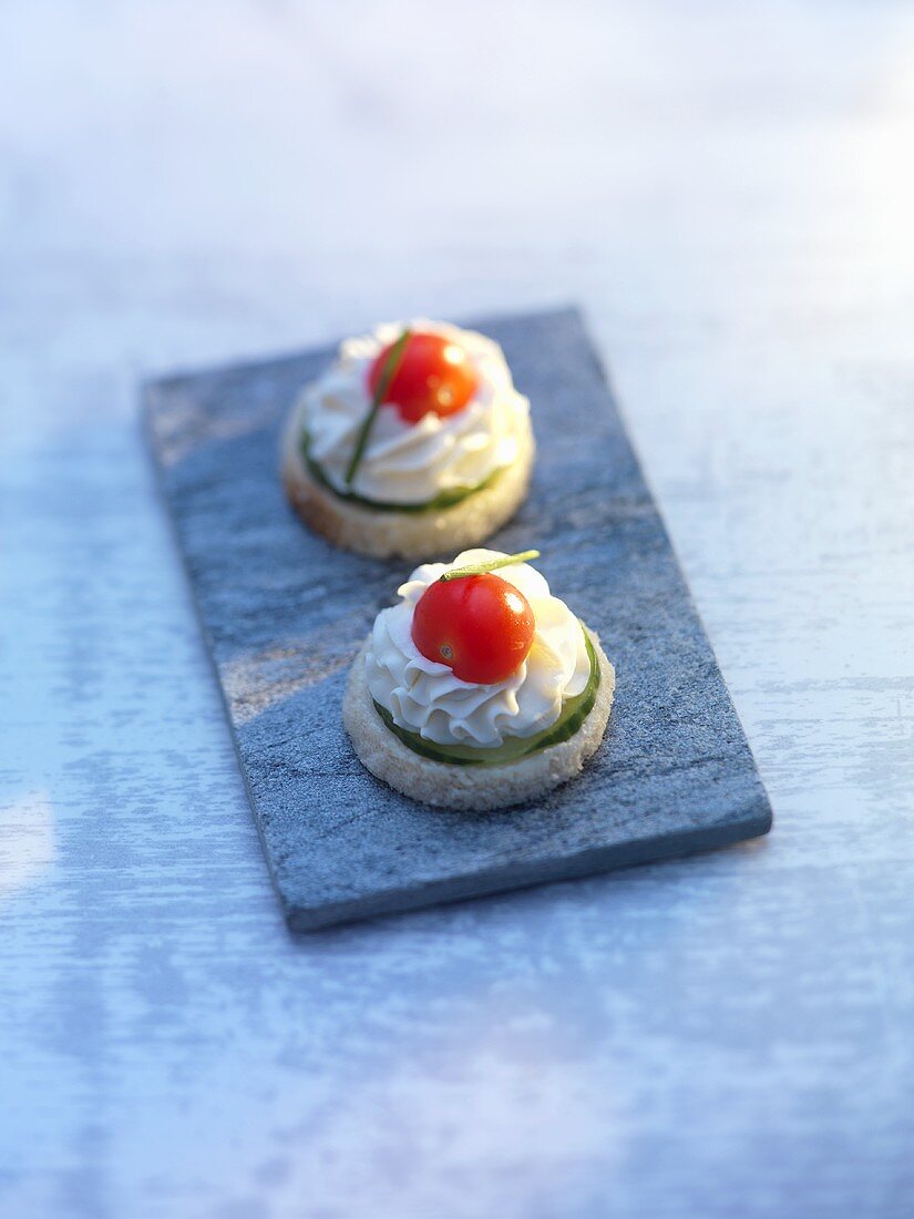 Two cucumber, cherry tomato and mayonnaise canapés