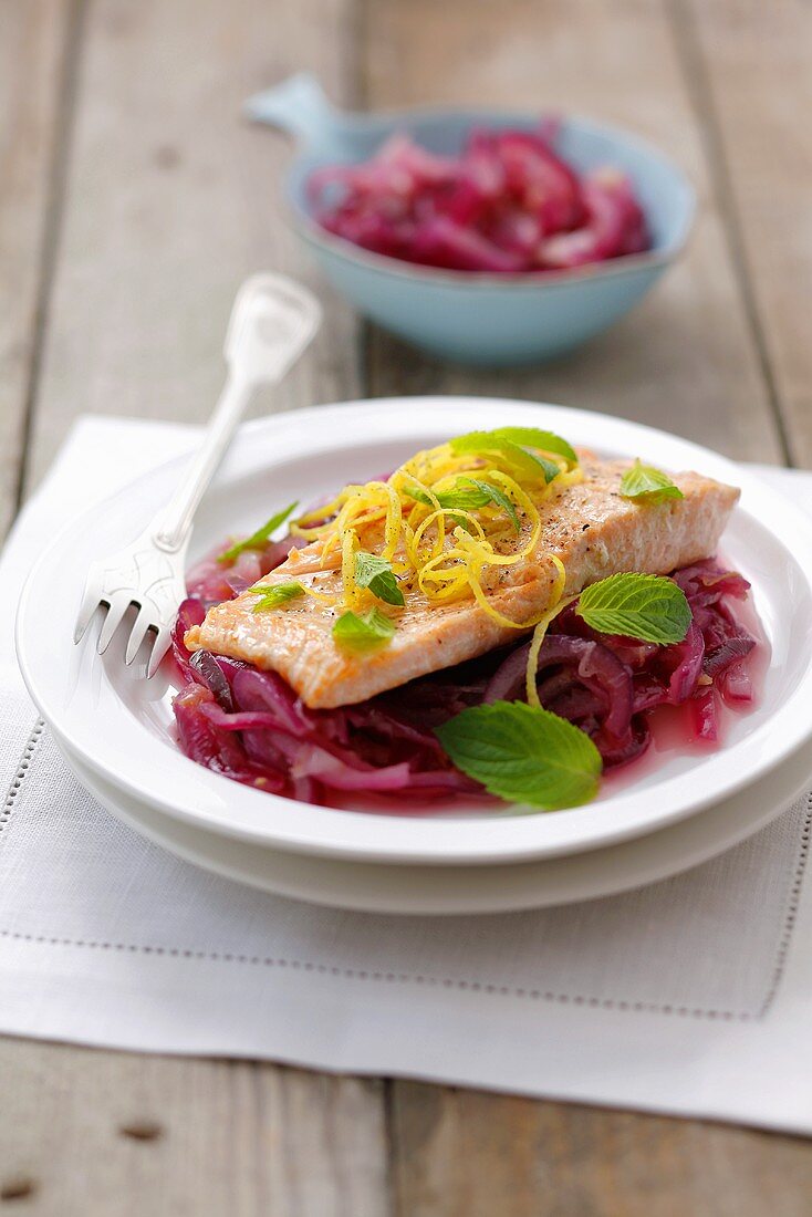Salmon trout with lemon and mint on red onions