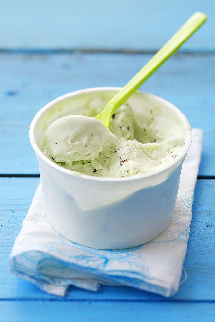 Mint ice cream in a plastic tub