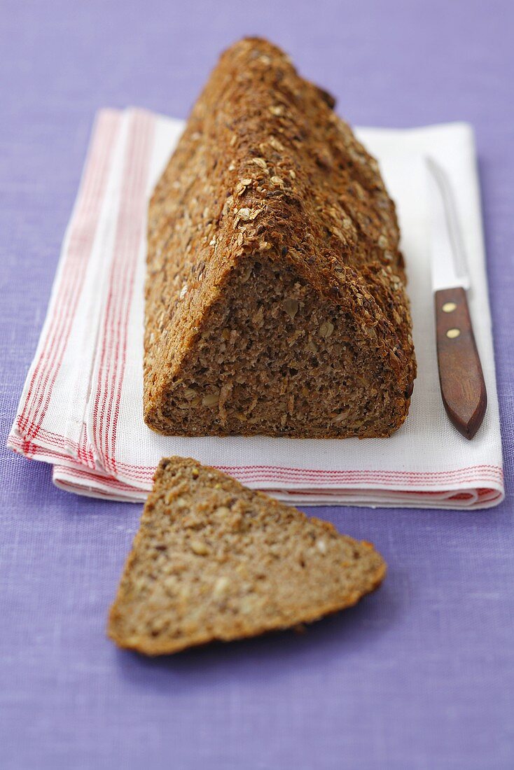 Triangular loaf of wholemeal bread with oats & sunflower seeds