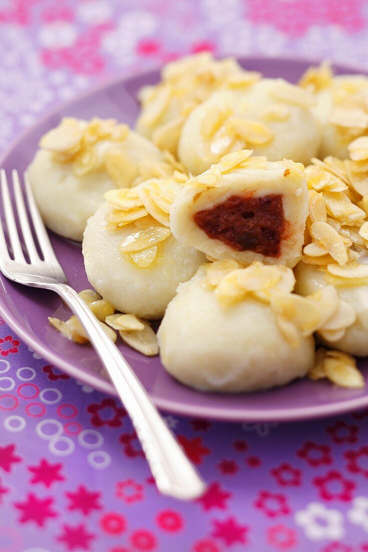 Potato dumplings with plum filling and buttered almonds