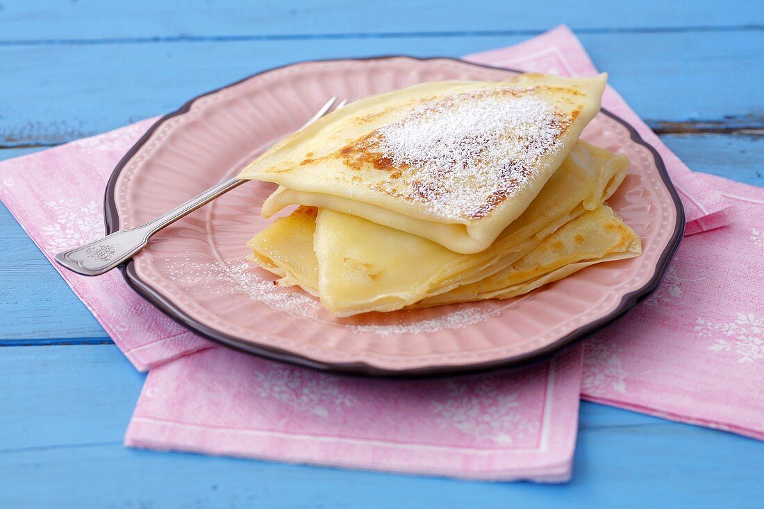 Crêpes filled with soft cheese and dusted with icing sugar